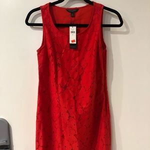 Red dress with floral lace overlay.